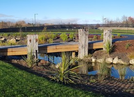 Timber bridges allow contact with the water, and good circulation for cyclists or joggers. The bridges are flanked by historic salvaged wharf beams, sourced from Lyttelton Port