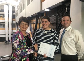 Marilyn Best from Megabits and Michael Wright (NZILA Wellington Branch Secretary) present Hannah Carson with her award.