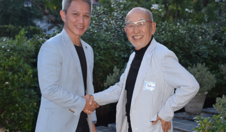 Outgoing president Damian Tang (left) congratulating the incoming president Fumiaki Takano, in the grounds of Circa 1900