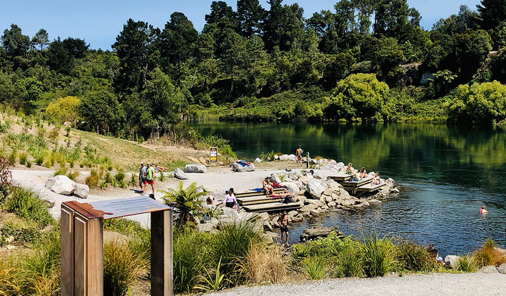 View towards the bathing platforms and carved story board.