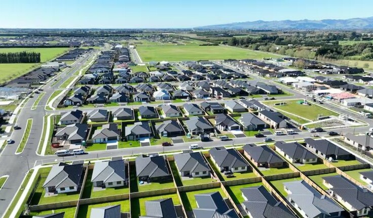 This drone image shows a farm in Rolleston awaiting further suburban conversion, with roads starting and stopping on either side of the farm. Donald Royds, CC BY-SA