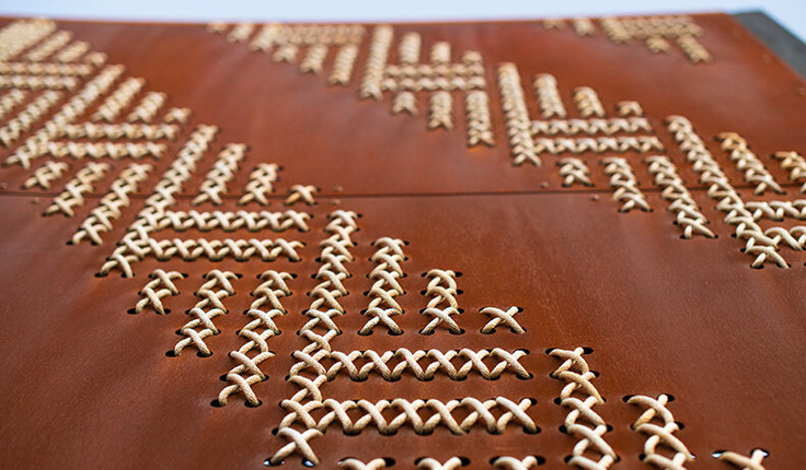 One hundred and twelve steel tukutuku panels, punched with 53,900 individual holes have been woven with 7.3km of cord by volunteers from Ngāti Oneone and DOC, Gisborne District Council and other skilled weavers from around Tairawhiti. Nick Tupara, Ngati Oneone artist and representative, developed the woven designs incorporating patterns kaokao, poutama, roimata tōroa, pātiki and patterns specific to Te Poho o Rāwiri Marae. Creating the panels was a physical challenge because of the sheer size, scale and materials of the tukutuku – steel and rope - compared to the traditional harakeke and slat board.