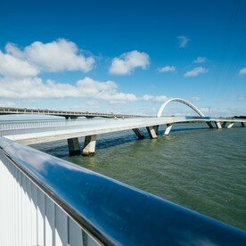 A structural arch and vee piers carry the bridge above the tide and restore safe east west passage for more craft.